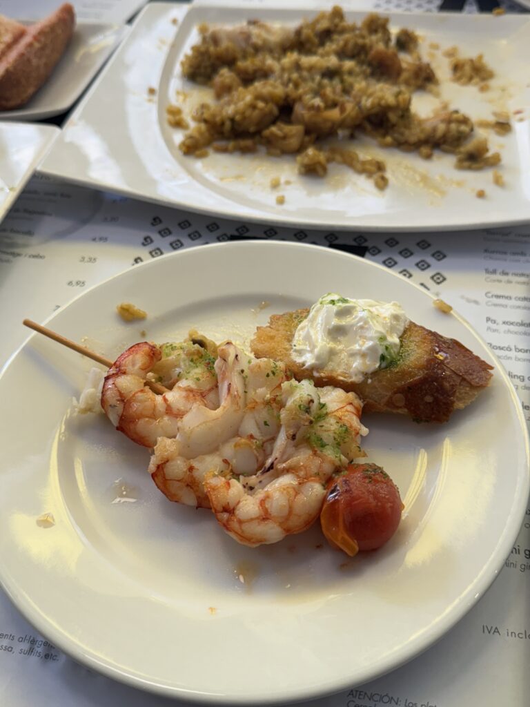 An array of colorful tapas dishes on a rustic wooden table, showcasing Spanish culinary delights in Barcelona.