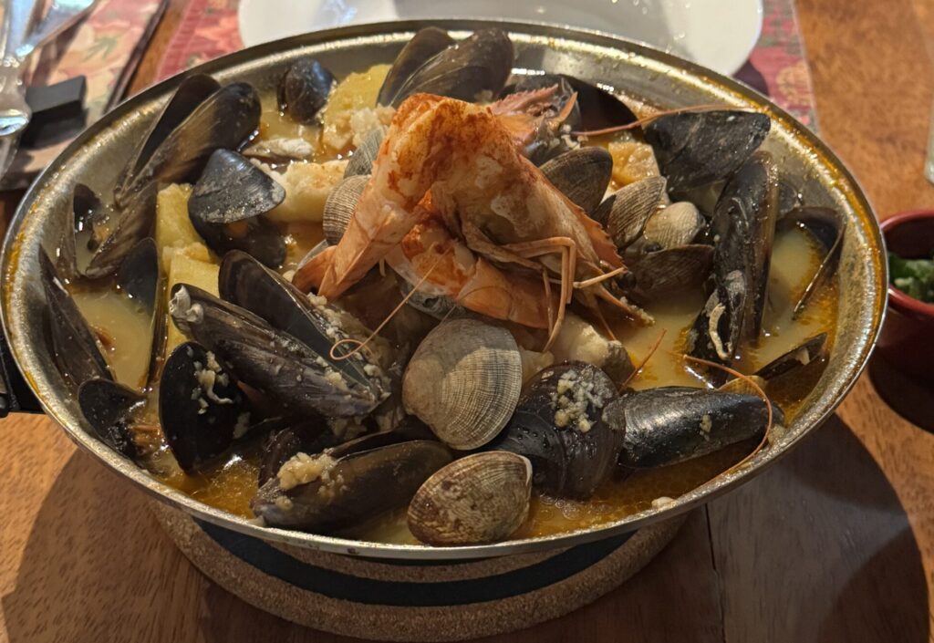 An assortment of colorful and artfully arranged tapas dishes, showcasing a variety of textures and flavors, served on rustic wooden platters